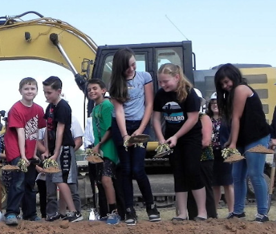 students breaking ground at new school 